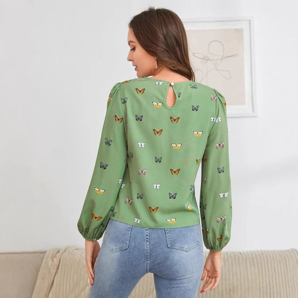 Women's green long-sleeved loose shirt with butterfly print pattern.