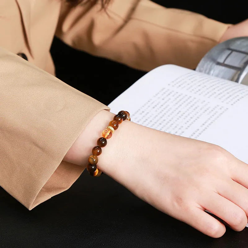 Close-up of a women's yellow tiger-eye stone and crystal bracelet with 8mm round beads.
