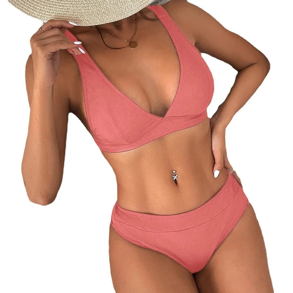 Women's black ribbed lace-up split bikini swimsuit laid flat, showing front design detail.