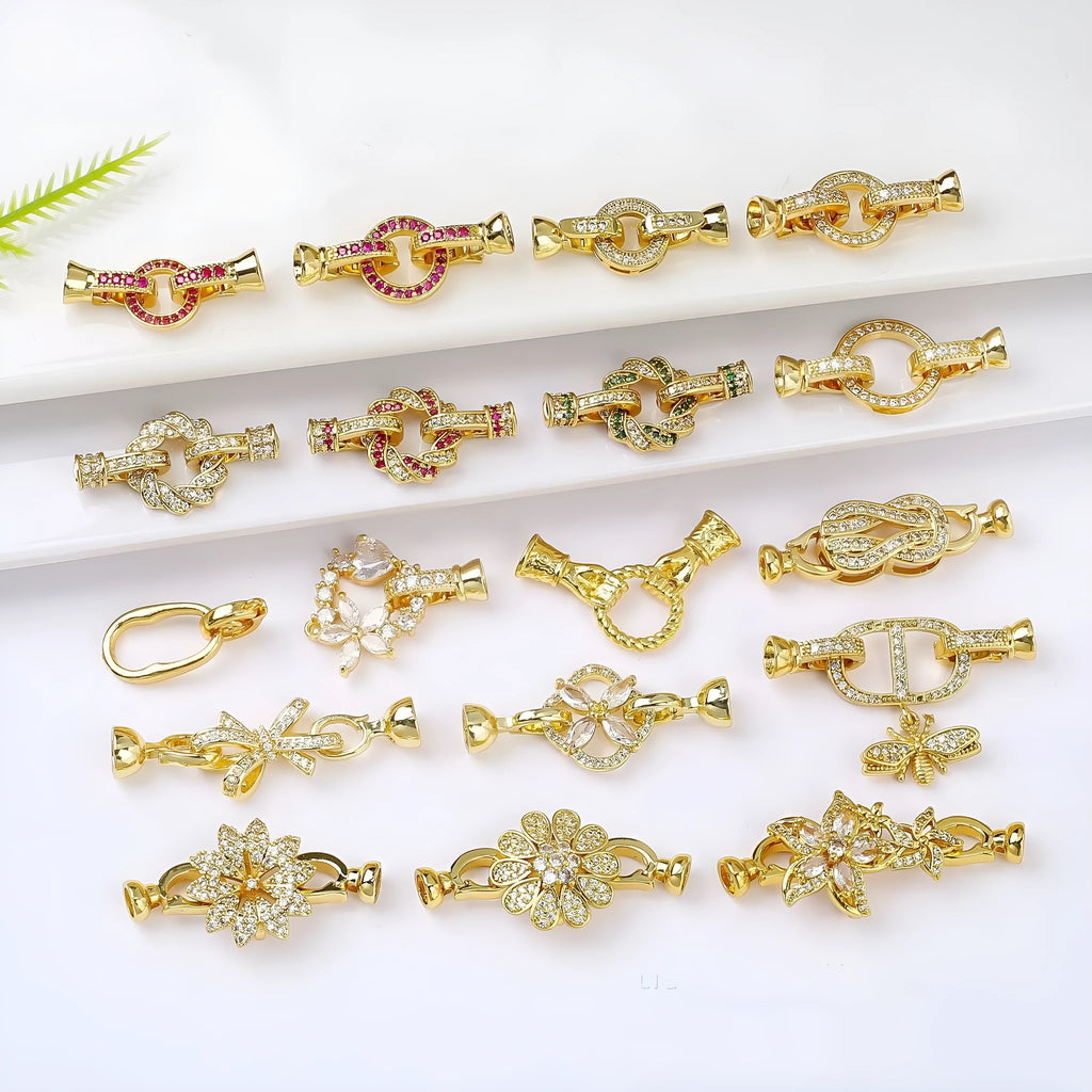 Small gold-coloured jewellery clasp with a closed loop, isolated on white background.