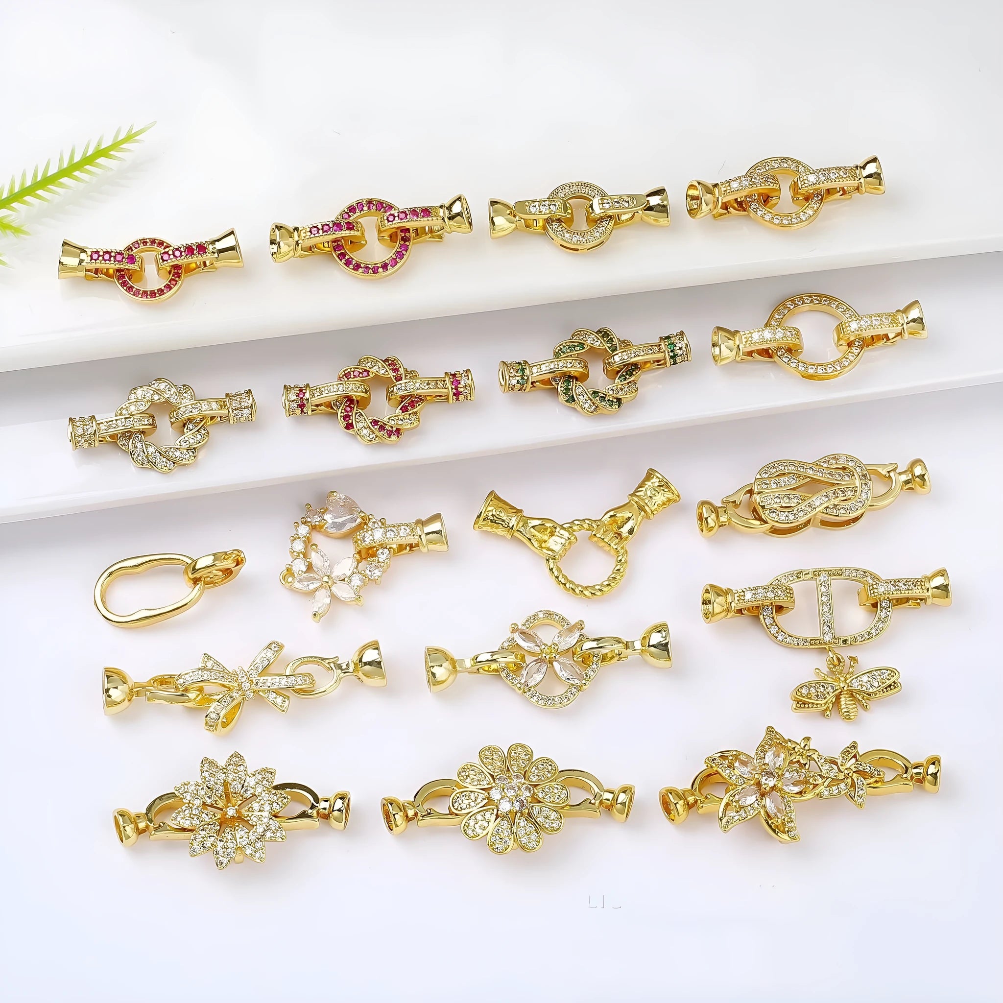 Small gold-coloured jewellery clasp with a closed loop, isolated on white background.