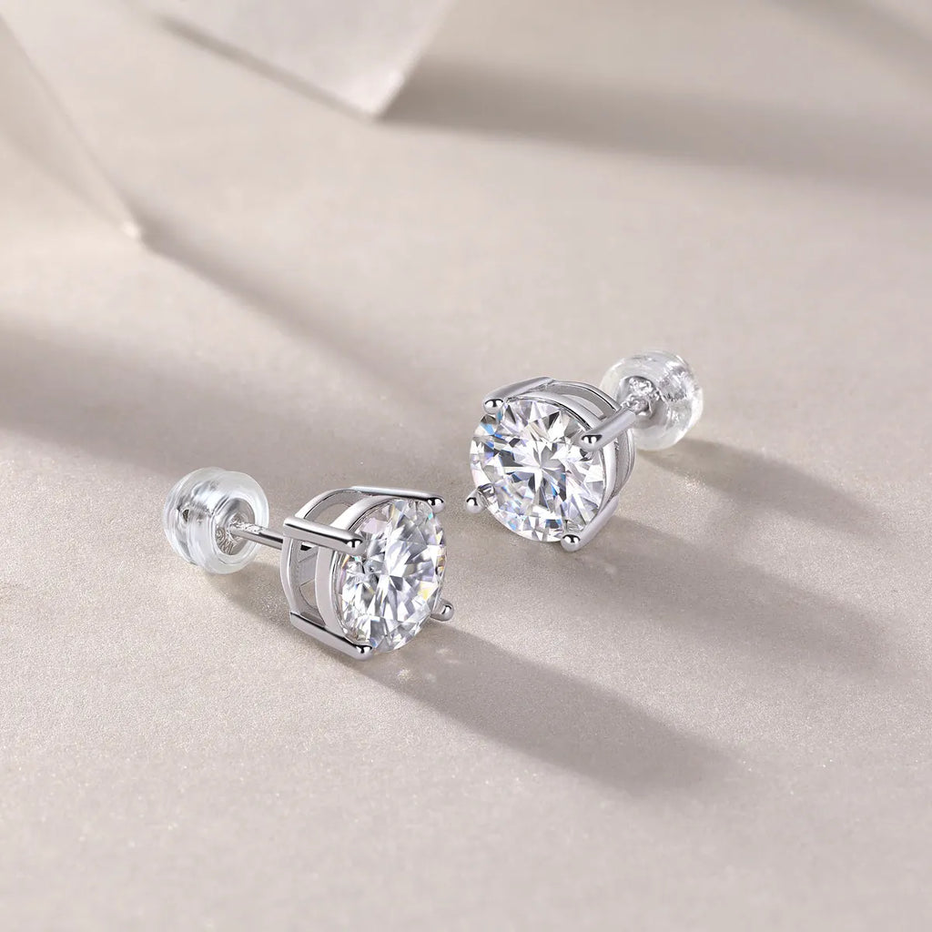 Pair of moissanite stud earrings with platinum-plated S925 silver settings, on a gift box, available in black or transparent stones