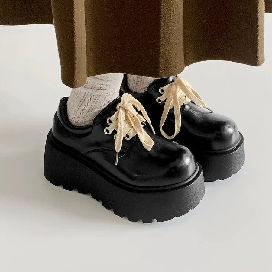 Matte black women's lace-up shoes with a chunky 6-8cm heel and round toe on a white background.