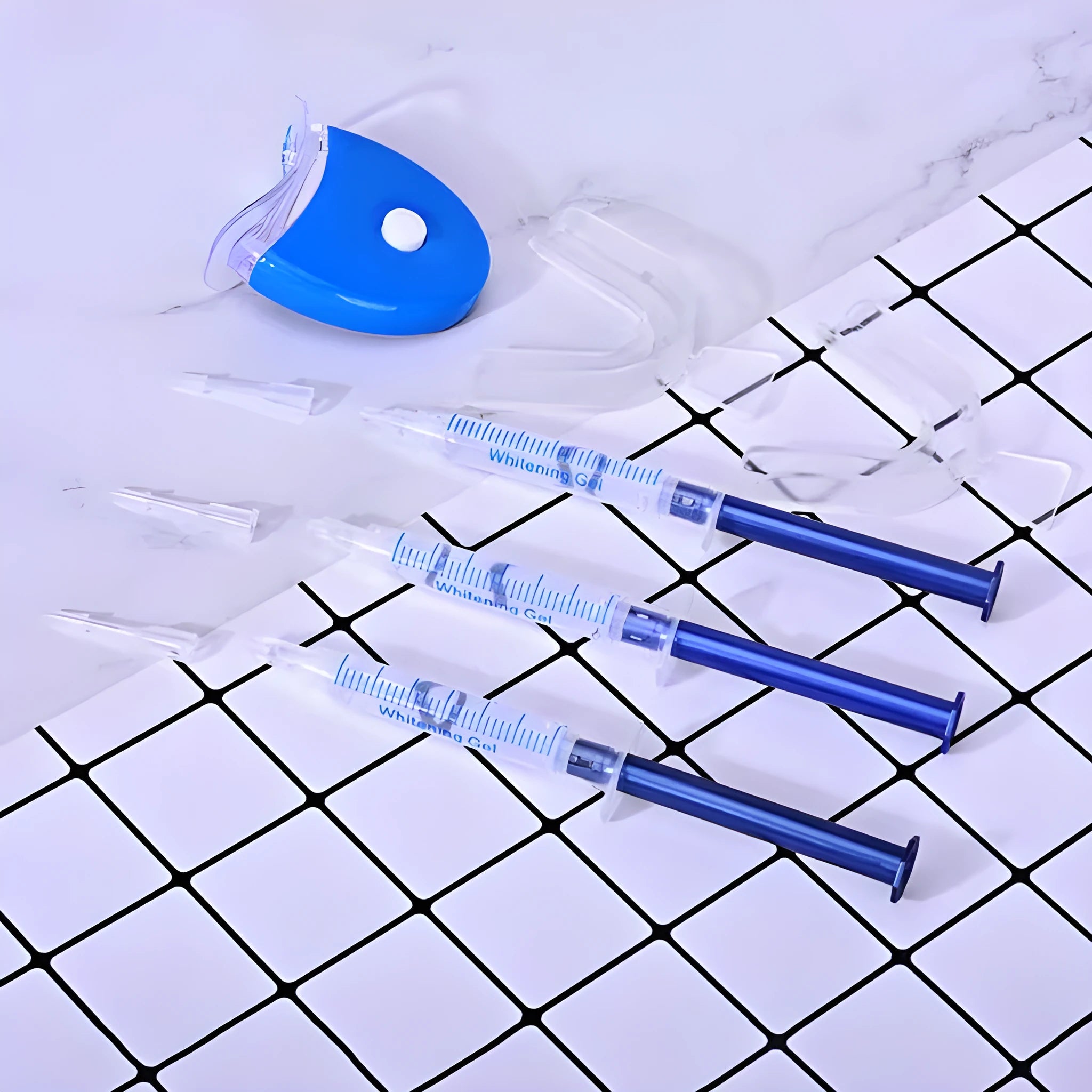 Teeth whitening kit with LED light and three 3ml gel sticks in blue packaging