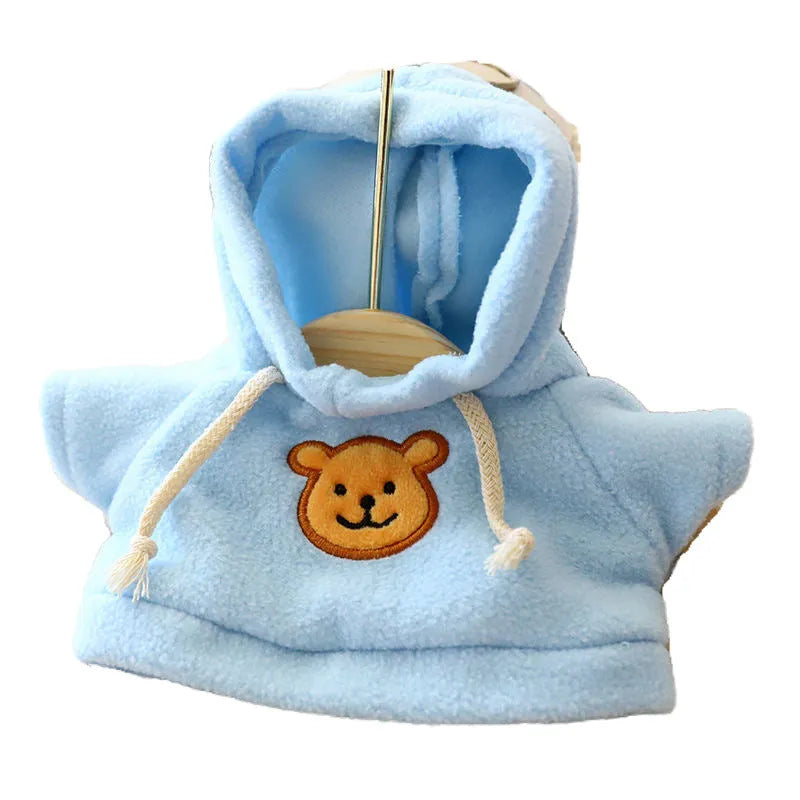 A dog wearing a blue hooded sweater, showing the hood up and the soft cloth fabric.