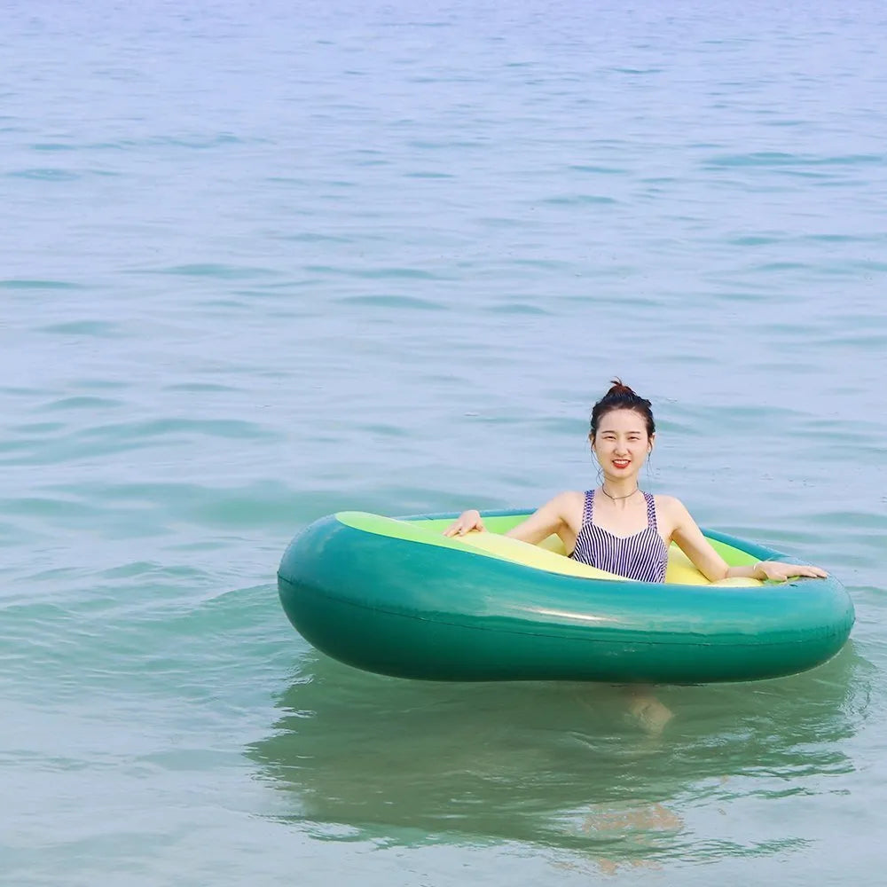 Giant green avocado-shaped inflatable pool float measuring 169cm by 130cm.