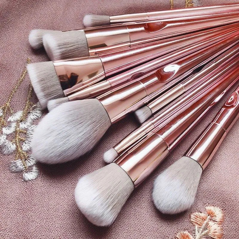Pink PVC makeup brush set with non-slip grip handle and soft bristles on a light background