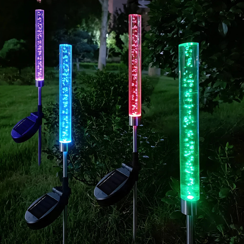 Solar bubble stick lawn lamp with colourful slow-flash crystal effect and warm light on a garden lawn