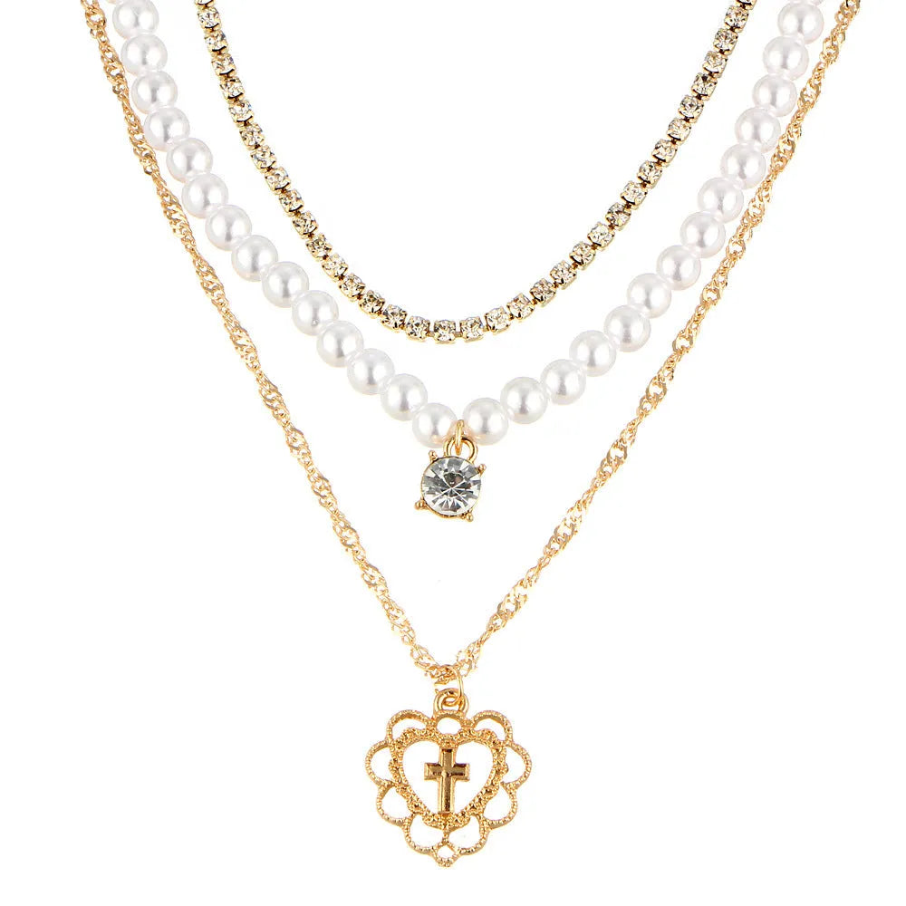Gold multi-layer rhinestone and imitation pearl necklace on a white background