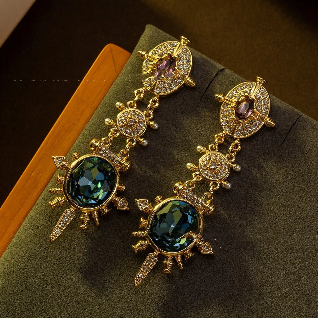 A pair of round geometric stud earrings with a gold finish and retro court style design.