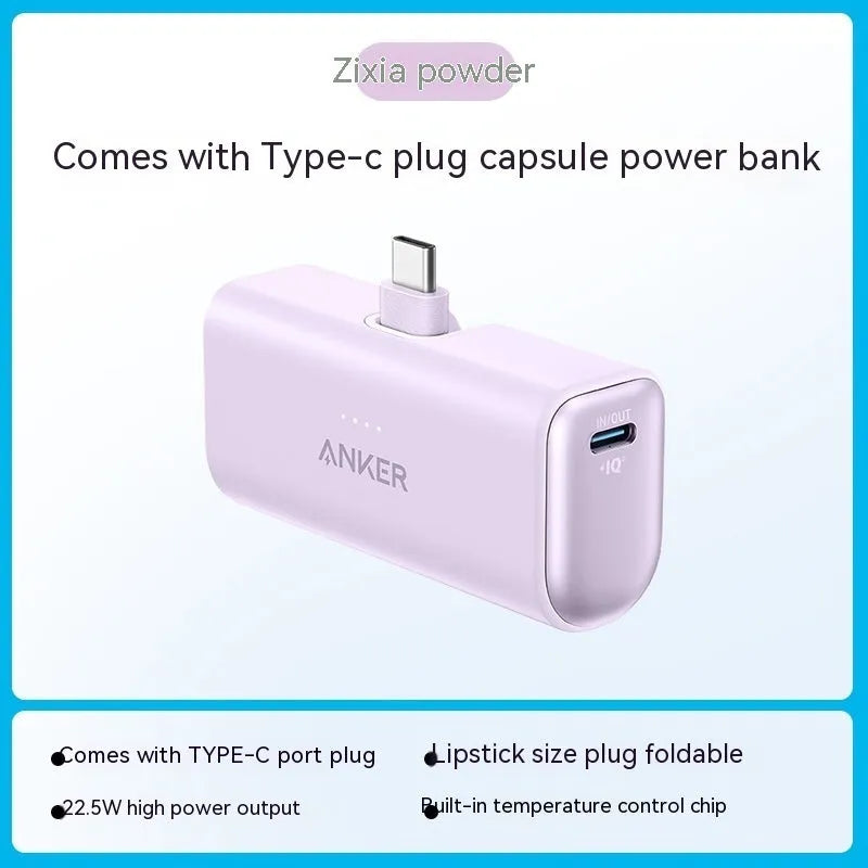 Small capsule-shaped power bank in multiple colours showing built-in foldable USB-C cable and compact size.