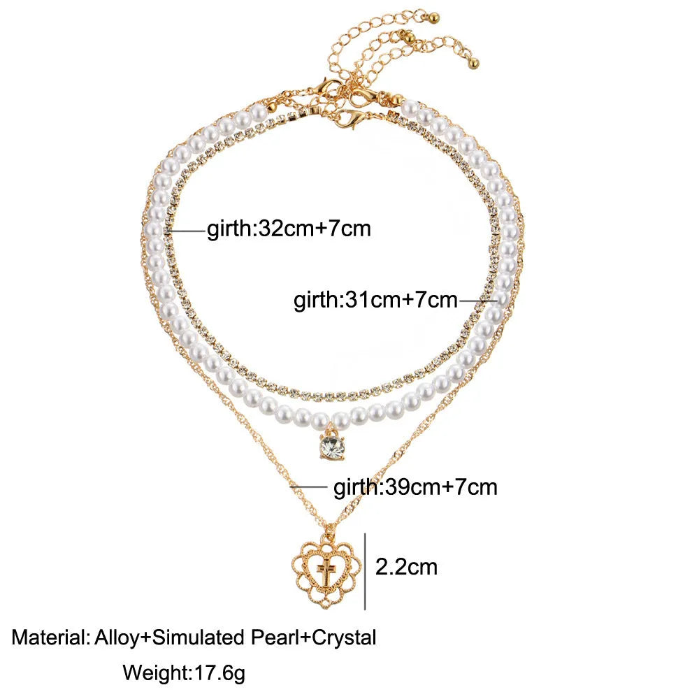Gold multi-layer rhinestone and imitation pearl necklace on a white background