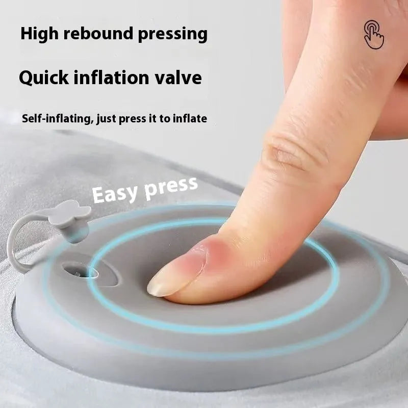 Grey inflatable seat cushion with a press valve, shown folded and inflated.