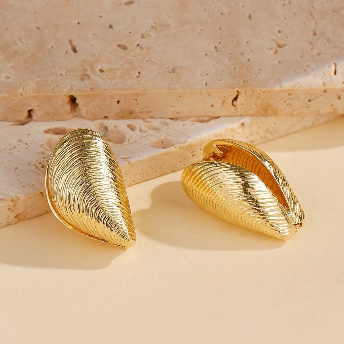 Gold geometric shell thread clip-on earrings on woman, beach ocean vacation style, zinc alloy electroplated ear clips