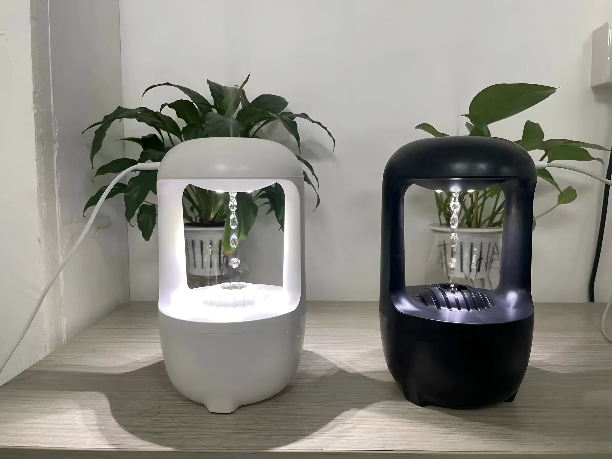 White anti-gravity humidifier showing water droplets flowing upwards, with USB cable and 500ml water tank.