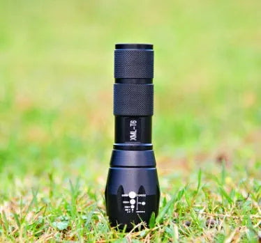 4000LM LED flashlight with aluminium alloy body and zoomable head, on a dark outdoor background
