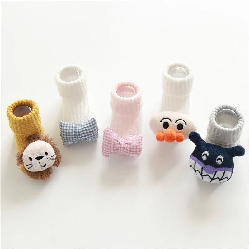 Cotton baby floor socks in various colours and patterns including pink bows, grey stars, and panda design.