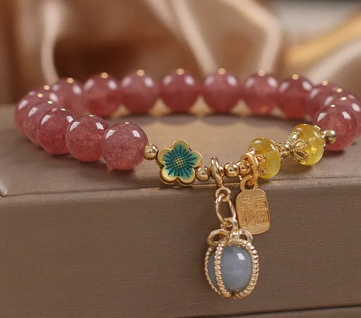 Red women's beaded bracelet with a strawberry quartz centre stone and sparkling rhinestones on an alloy chain.