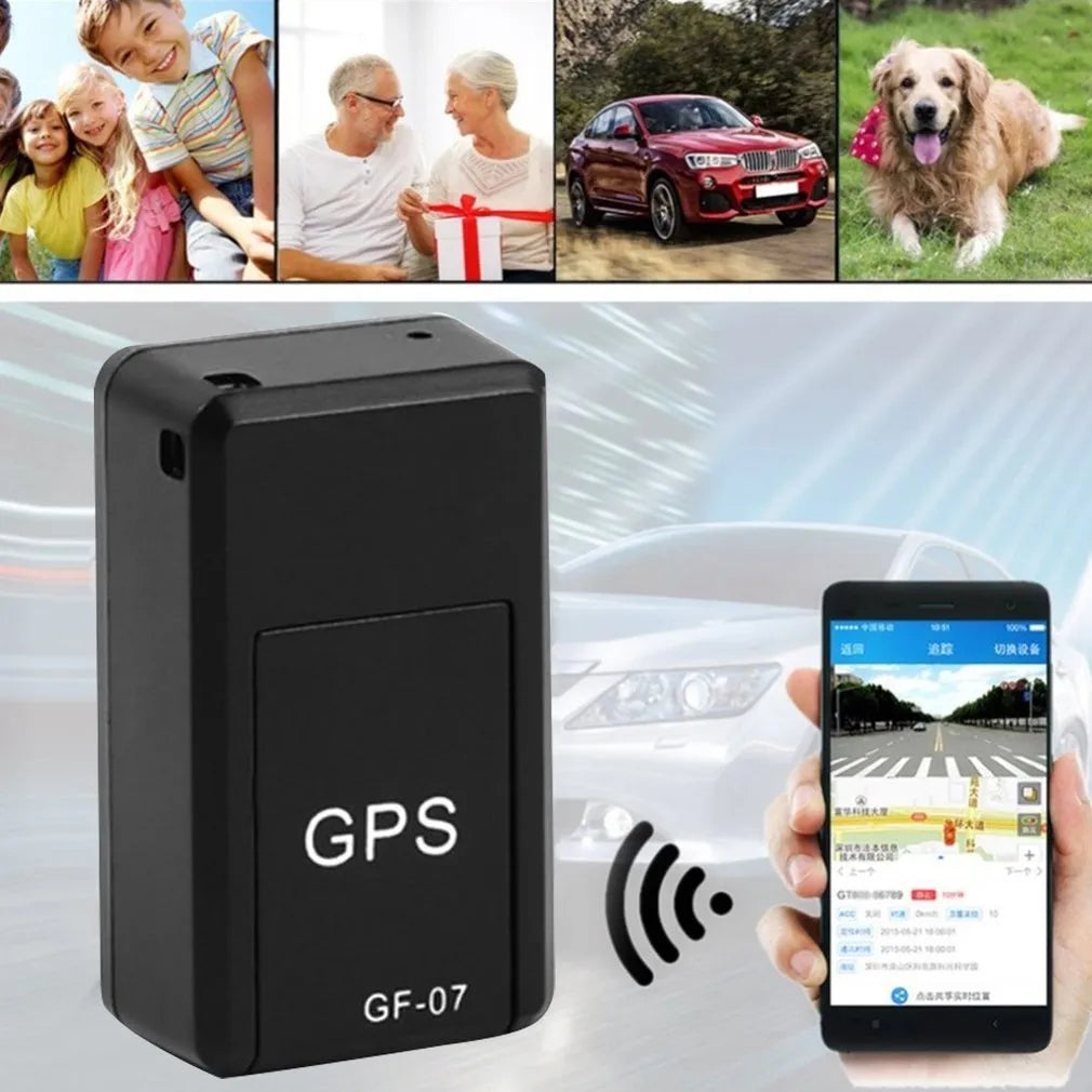 Small black magnetic GPS tracker device next to a micro-USB cable on a table.