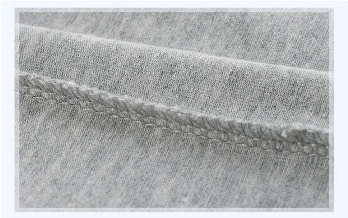 Grey children's cotton T-shirt laid flat, showing size tag with centimetre measurements.