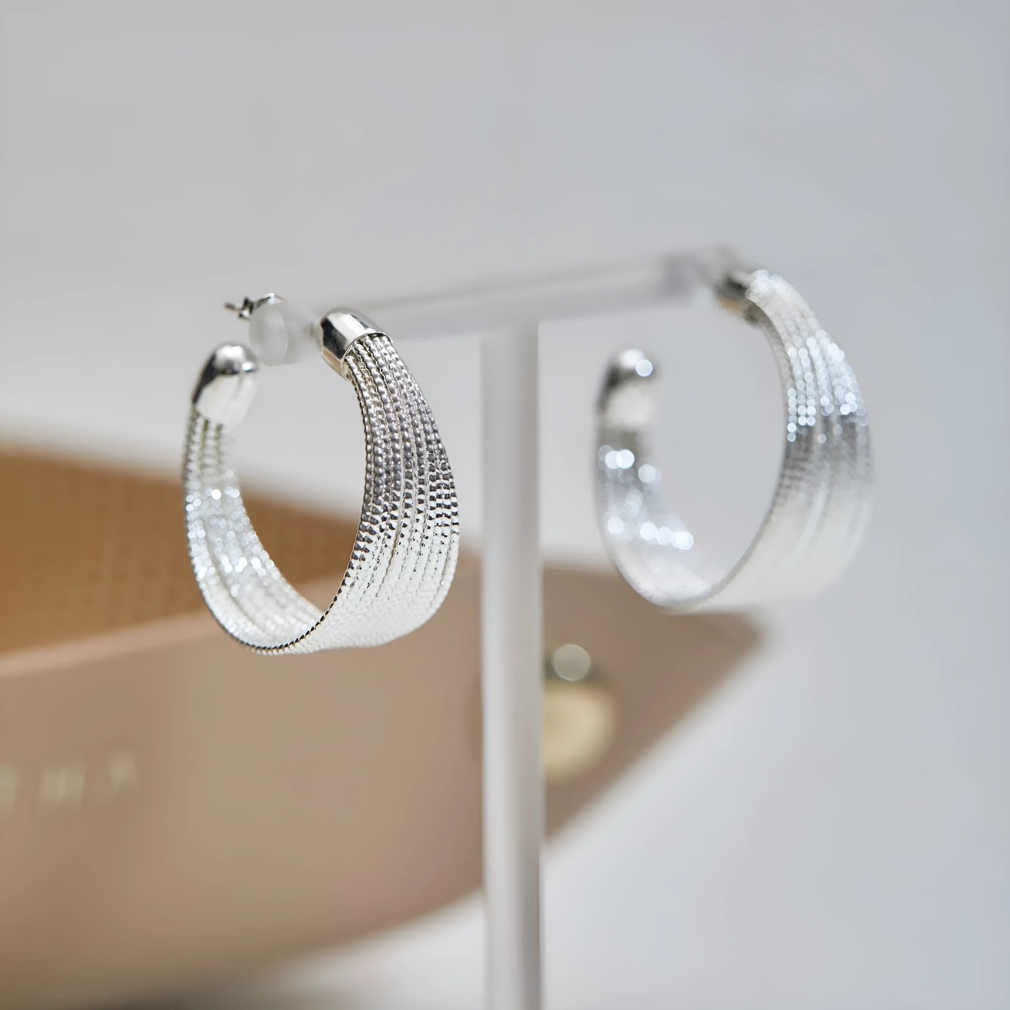 Geometric copper earrings with electroplated gold or silver finish showing stud and clip style options