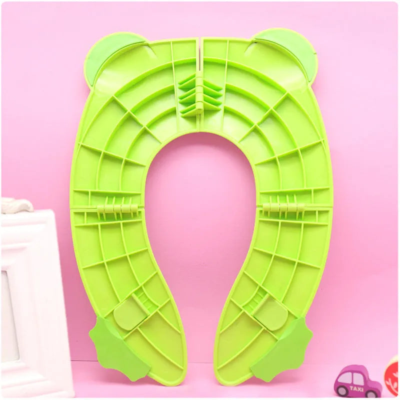 Children's toilet seat pad in PP, shown in blue or green with drawstring bag for toilet training