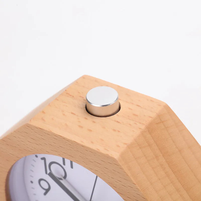 Wooden hexagonal alarm clock with luminous dial and beech finish on a nightstand