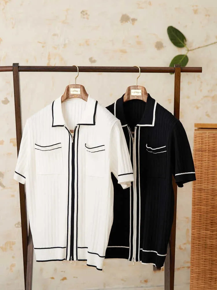Man's slim fitting short sleeve polo shirt with a lapel collar in black, made from a lightweight knitted fabric.