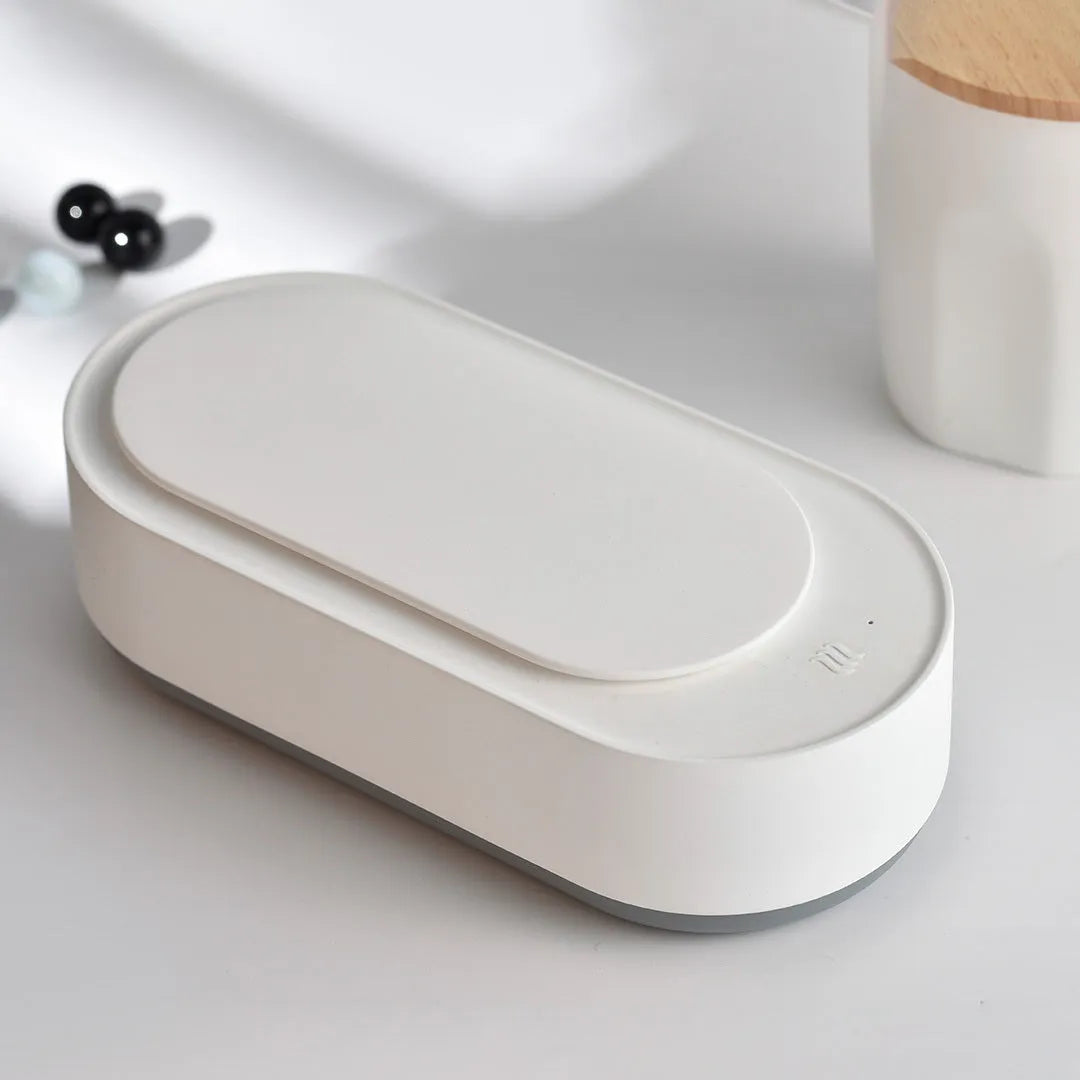 White portable ultrasonic cleaning machine with stainless steel tank and digital timer display.