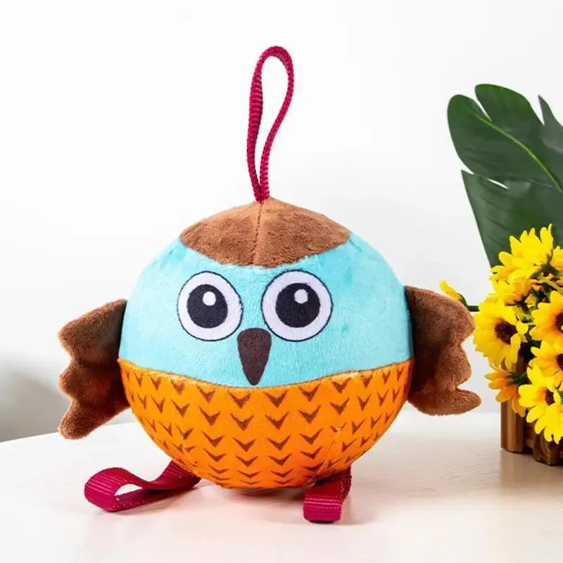 Orange Owl Ball interactive dog toy with velvet surface and rubber core on white background
