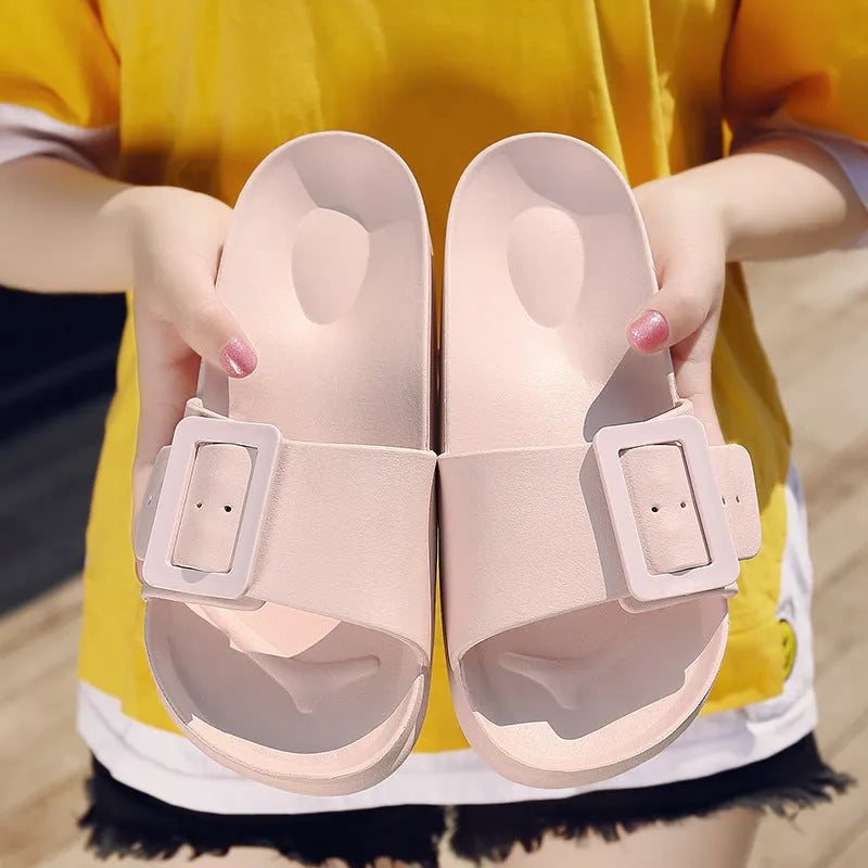 Women's grey blue flip-flop slippers with a silver adjustable buckle on the strap.