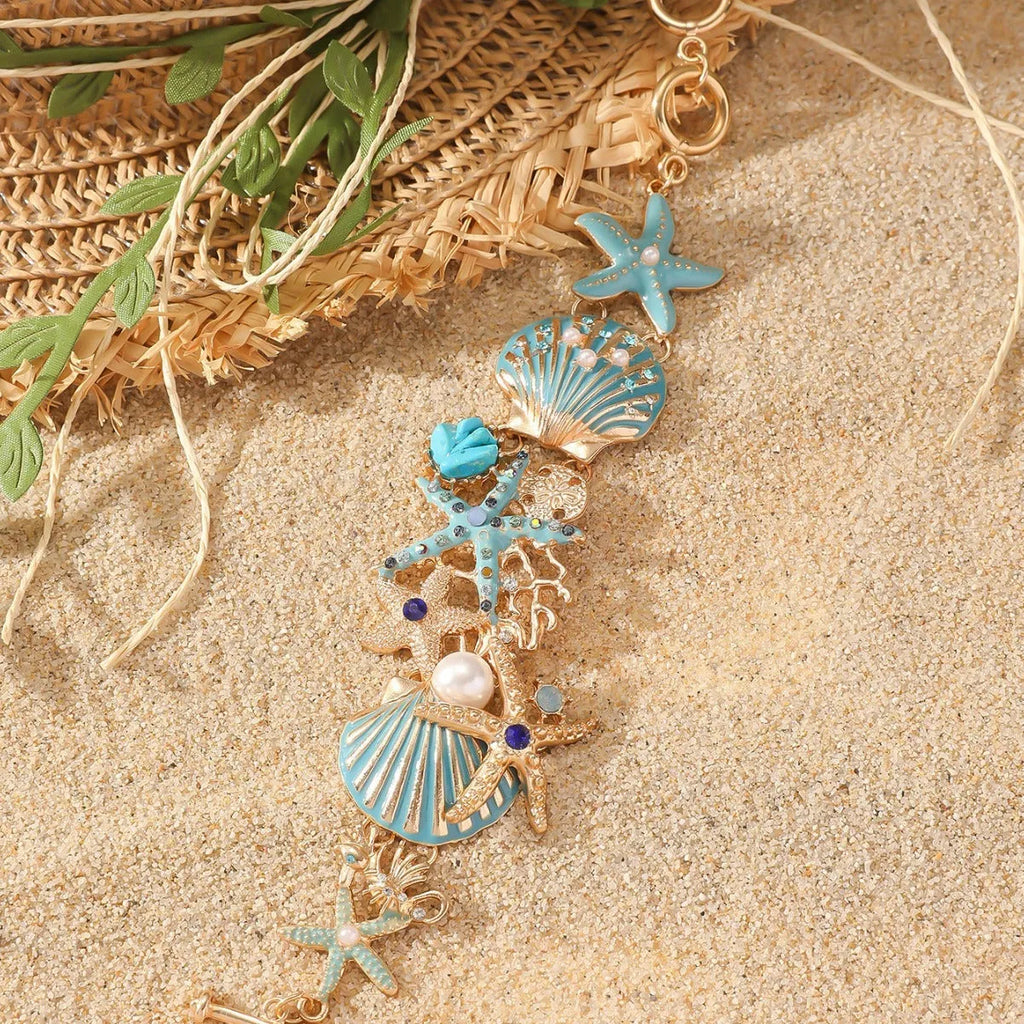 Women's alloy nautical bracelet with boat anchor and starfish charms in coral blue, red, or turquoise.