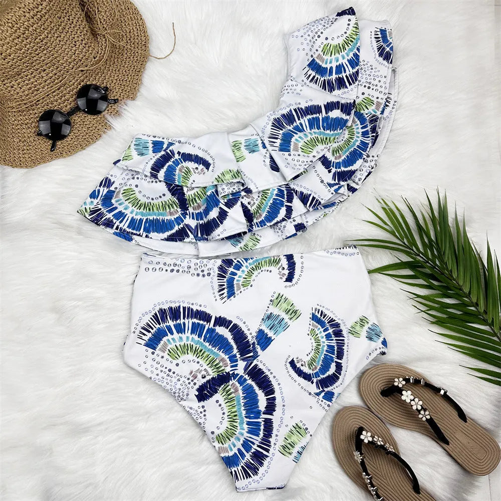 Women's white one-shoulder swimsuit with lotus leaf design and side split detail.