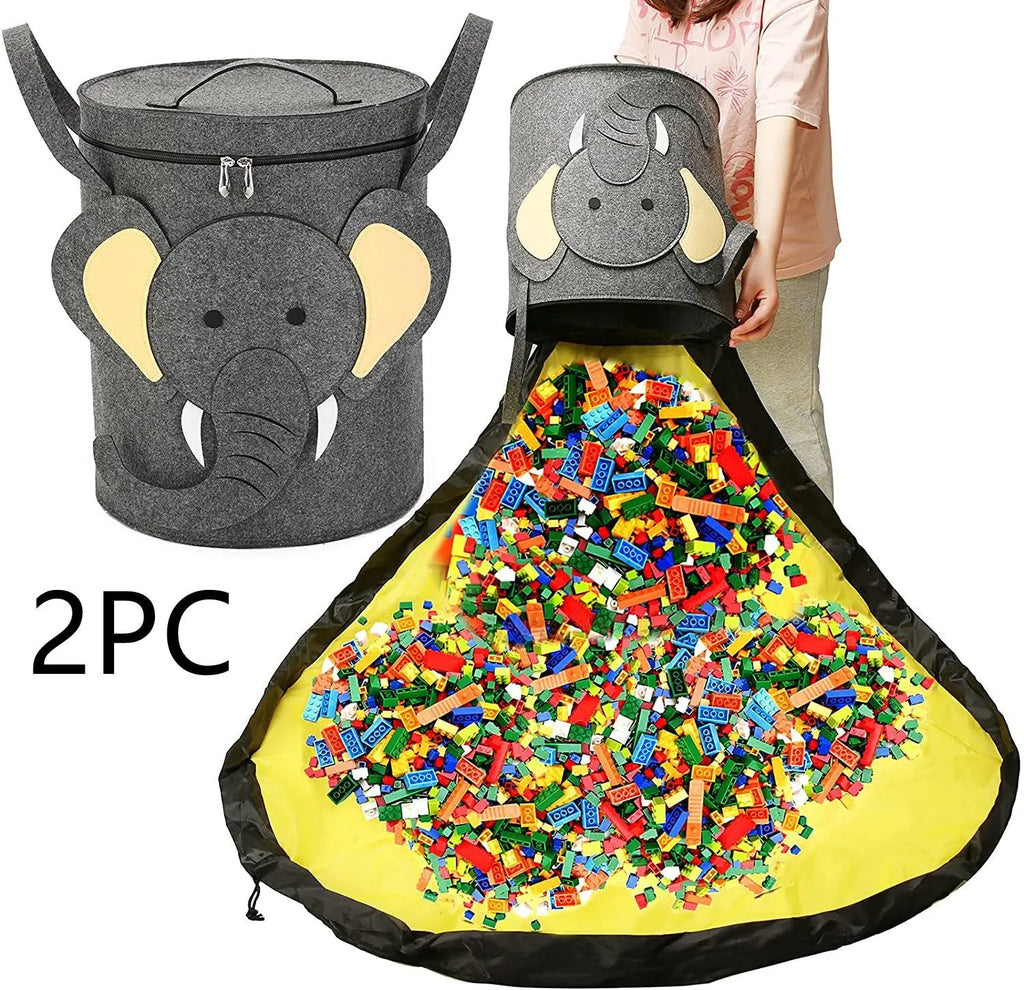 Green felt cube storage bag with pull rope, laid flat as a play mat next to toys.