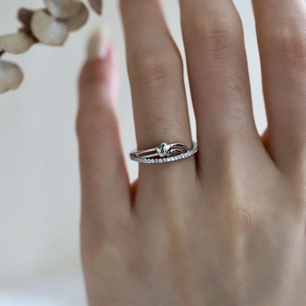 XINGX Korean-style women's S925 silver single-row diamond ring in white gold finish on a white background