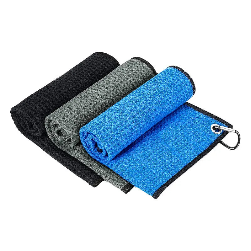 Waffle weave golf ball cleaning cloth towel in assorted colours showing textured surface.