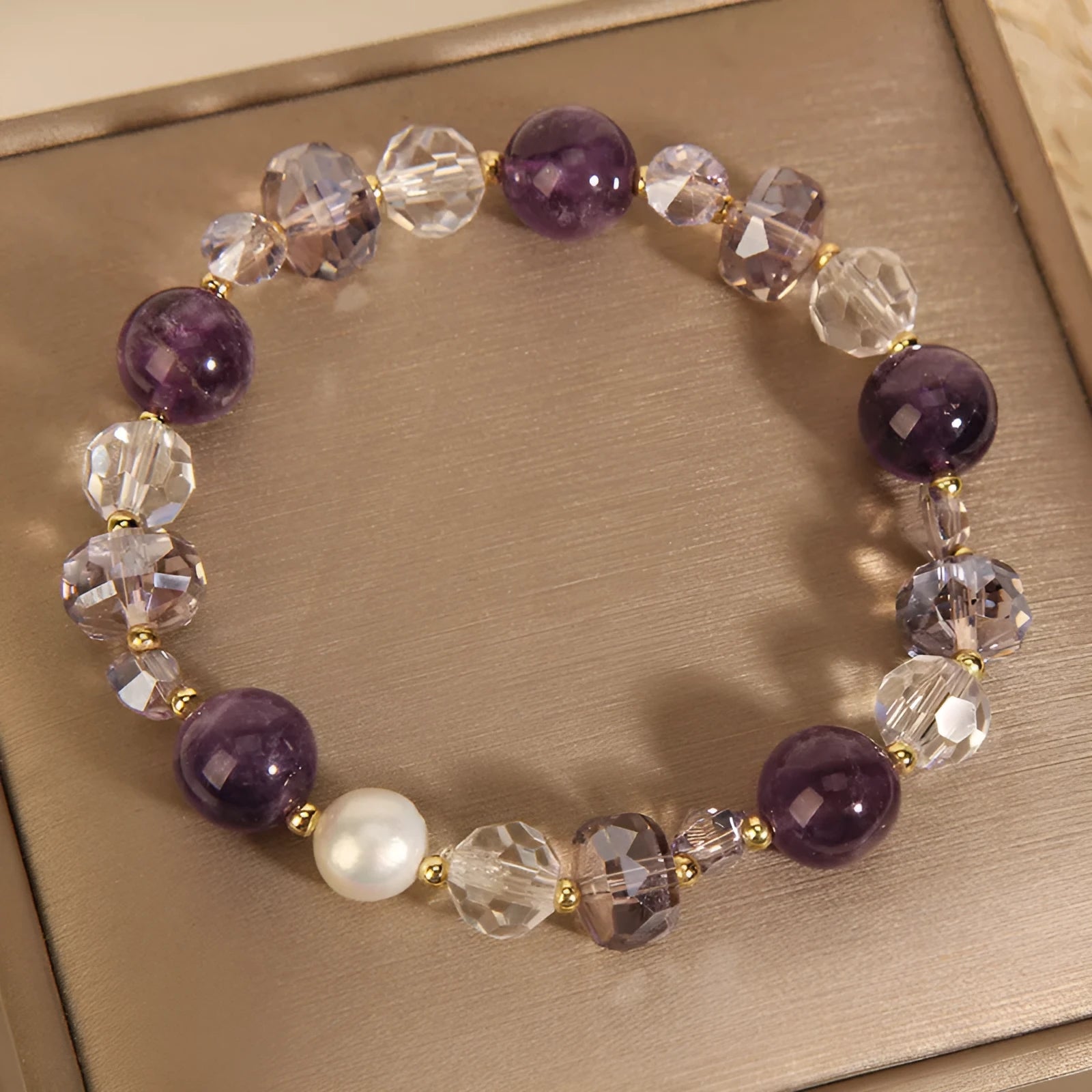 Women's artificial amethyst bracelet with four-leaf clover pendant and pearl accents on a U-shaped cuff.