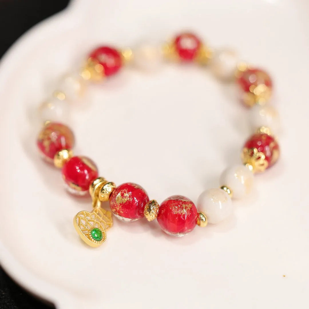 Gold foil coloured glaze ethnic bracelet with geometric Xingshi patterns and hanging gourd charms