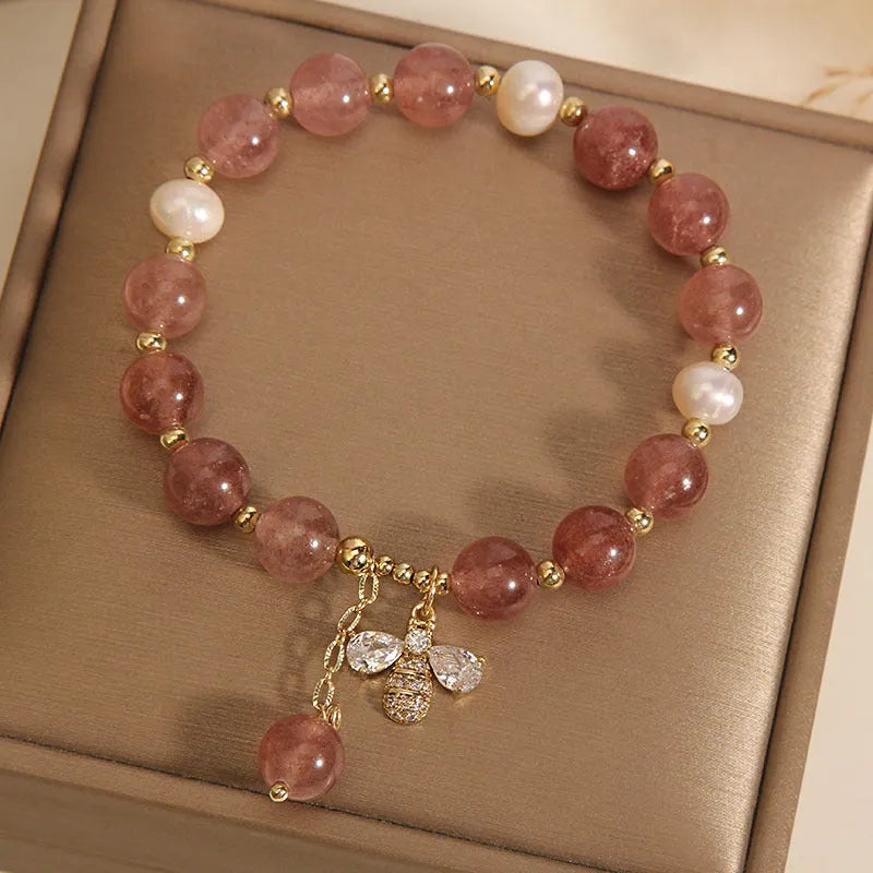 Women's bracelet with strawberry quartz stones, freshwater pearls, and zircon on an alloy chain.