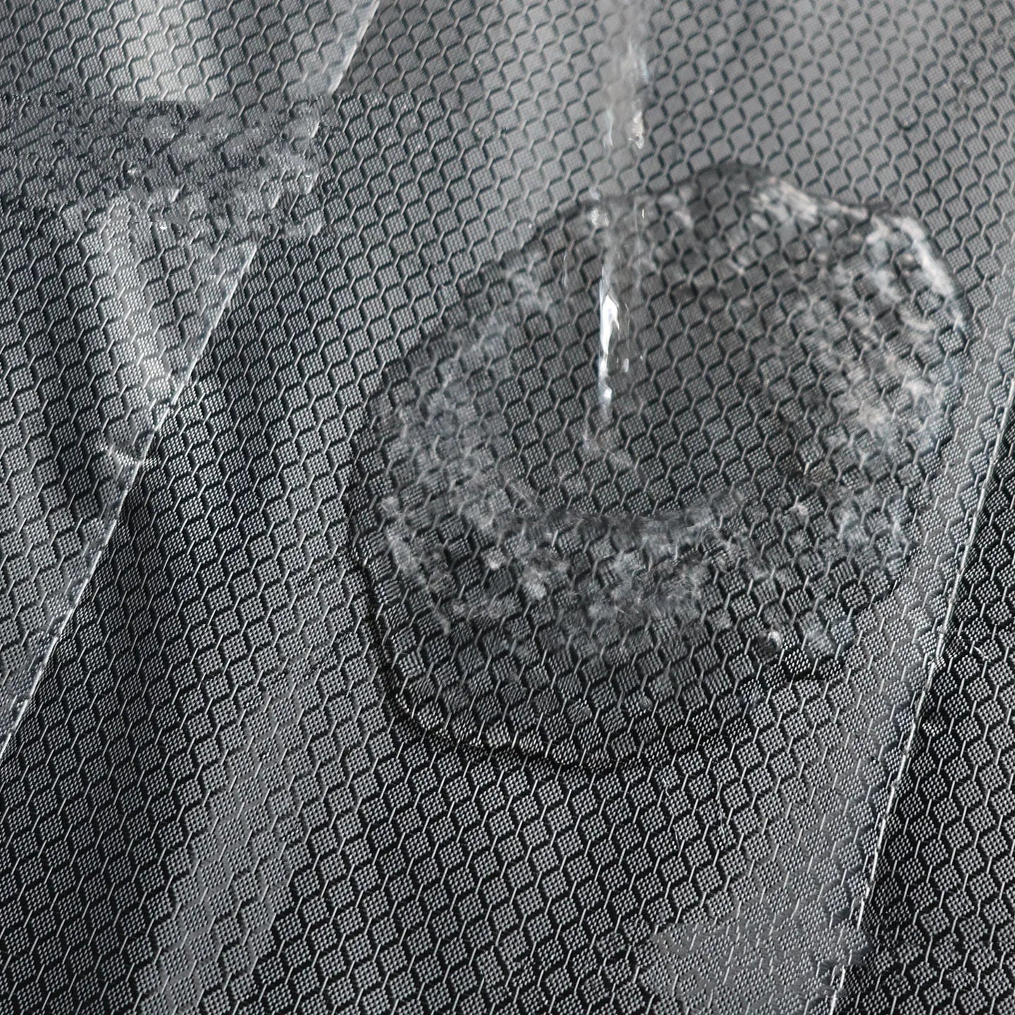 Magnetic strip cotton door curtain in a grey diamond lattice pattern, shown hanging over a doorway.