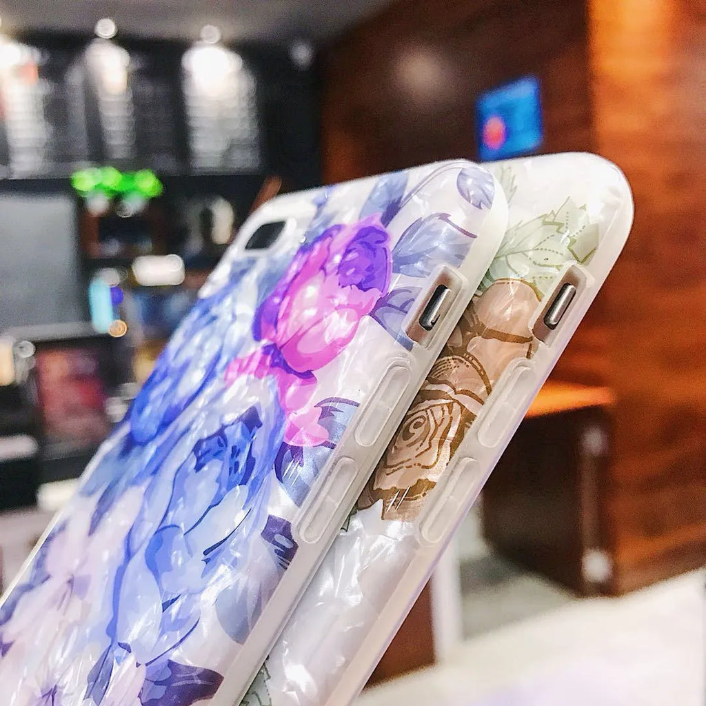 Soft TPU silicone iPhone case with a rose flower design on the back in brown, shown fitted to a phone.