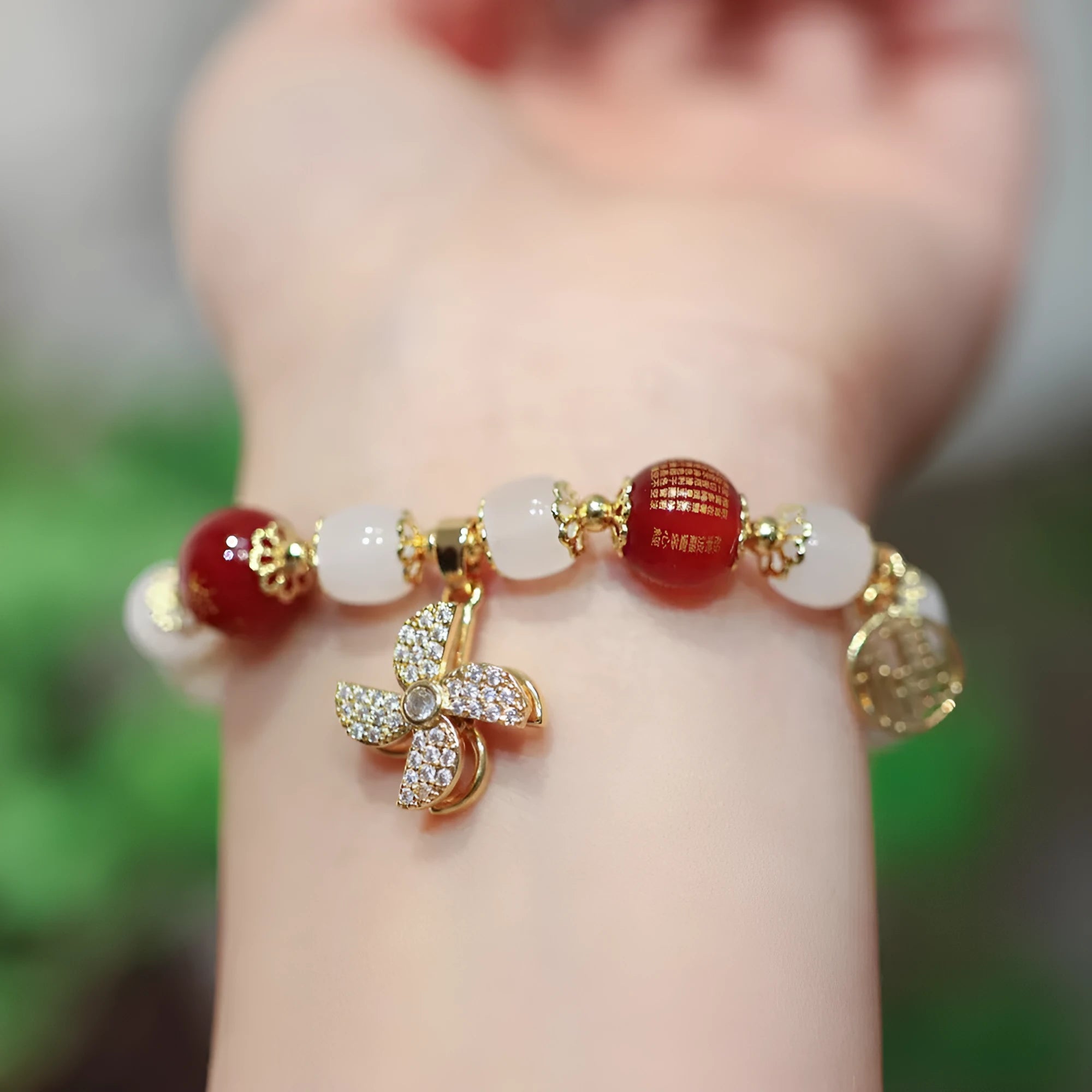Women's Chinese style glass bracelet with safety lock, fu character, windmill, bamboo, and jade charm elements
