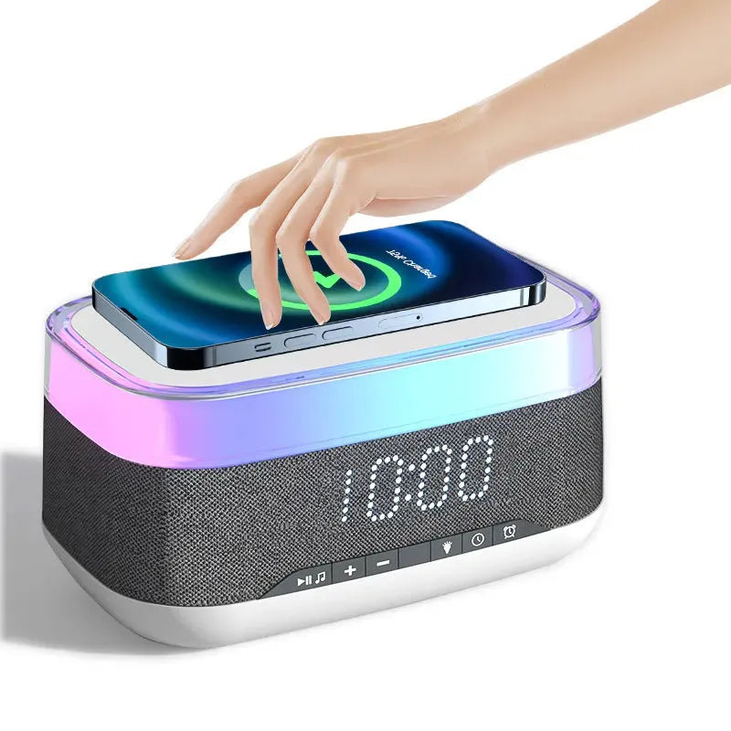 White multifunctional alarm clock with Bluetooth speaker and wireless charging pad showing night light illumination