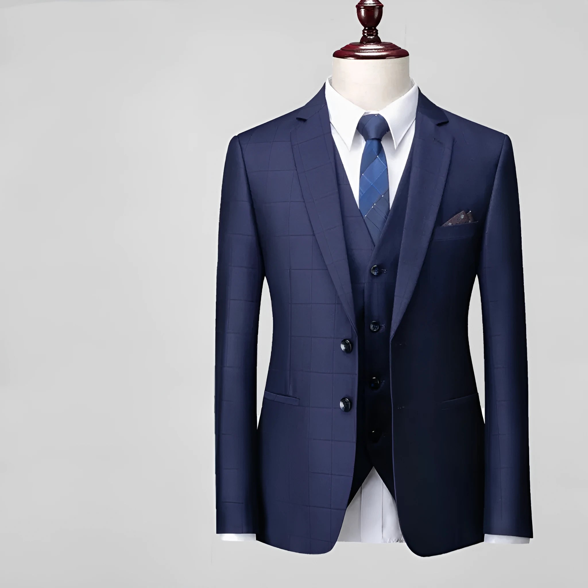 Men's navy blue plaid slim fit three-piece suit with jacket, vest, and trousers on a hanger