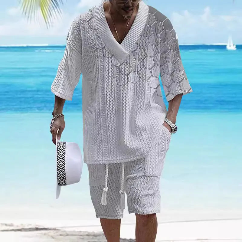 Man wearing a printed drop-shoulder knitted top and matching shorts from a leisure suit set.