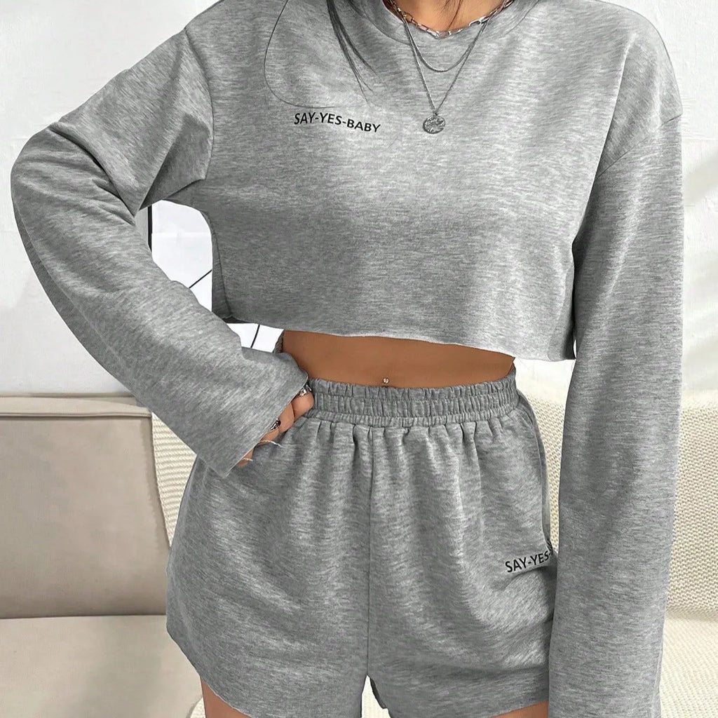 Grey women's long-sleeved T-shirt and matching shorts polyester suit set laid flat.