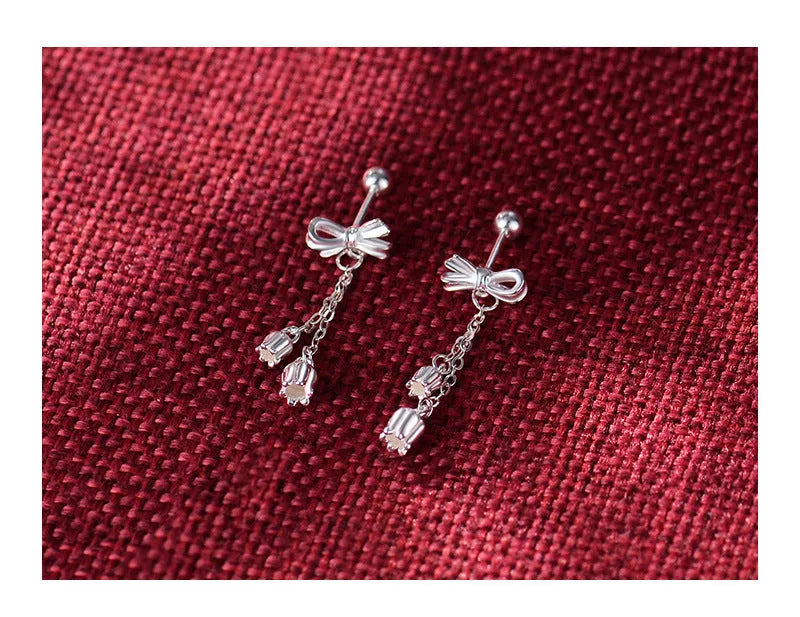 Silver bow ear studs with sweet tassel details and Korean style design for women