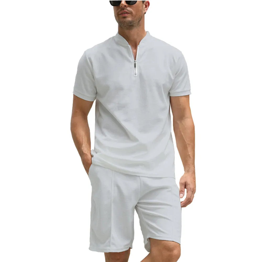 Men's solid colour polo shirt and matching trousers two-piece suit set on a hanger.