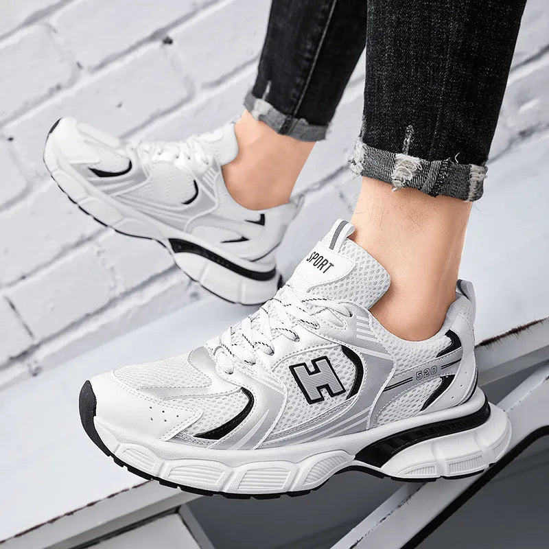 Men's mesh running shoes in black, white orange, and white and grey colours with plastic soles