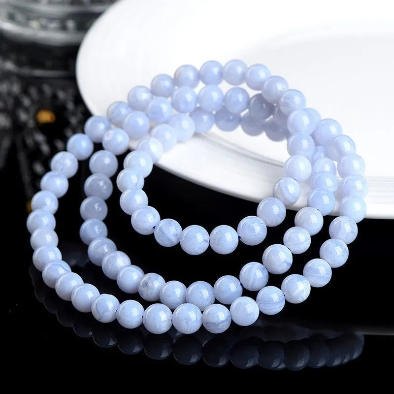 Blue agate beaded bracelet with Ruyi design elements and scattered striped beads